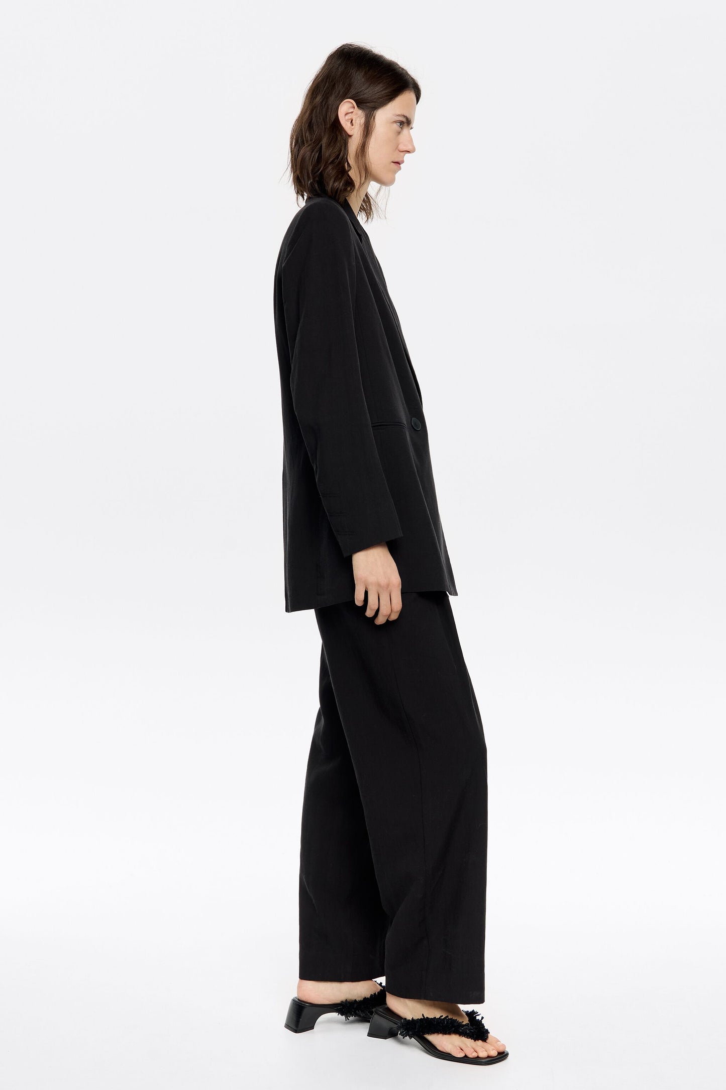 Black darted ankle-length trousers