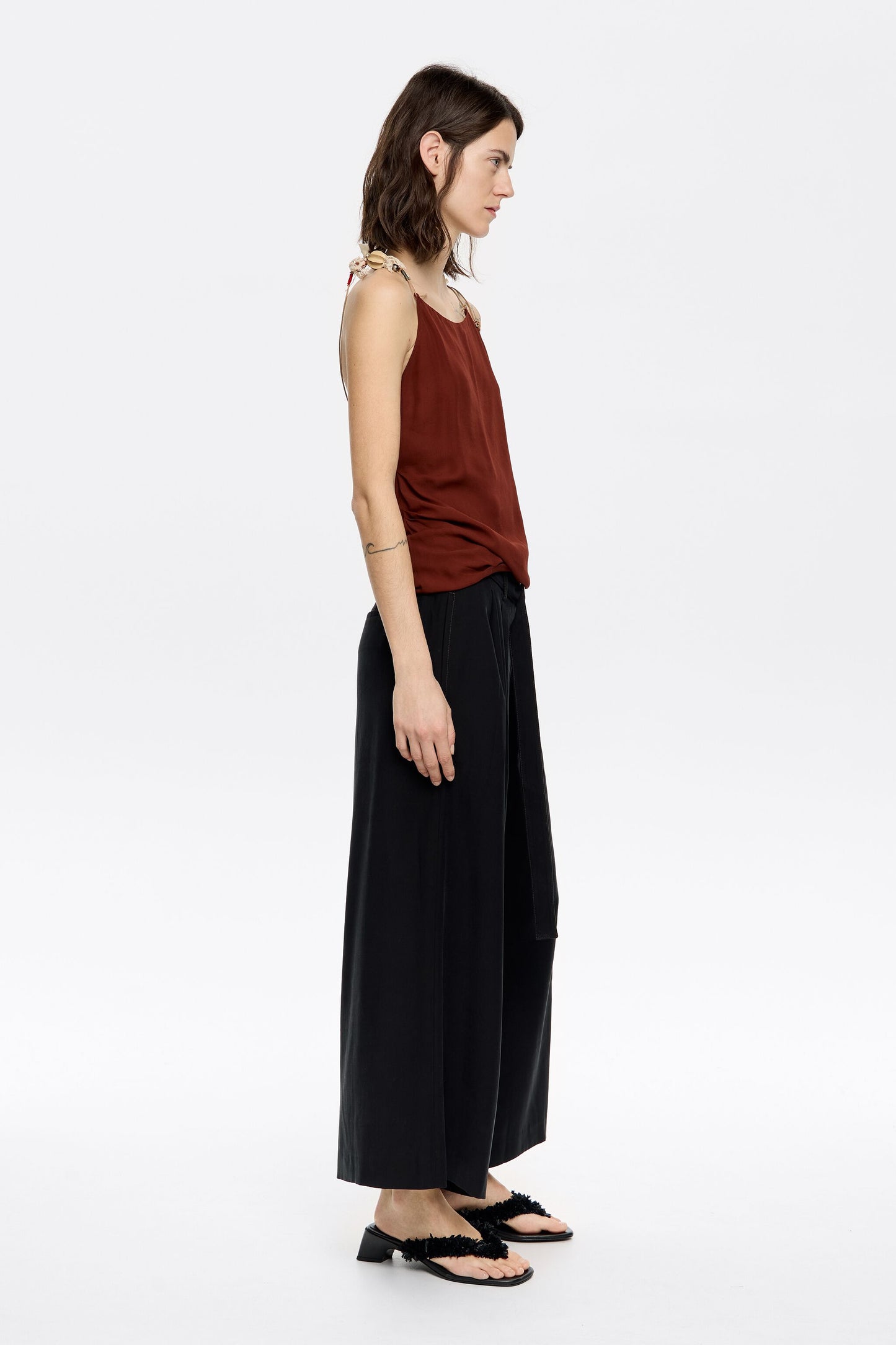 Black flared ankle-length trousers